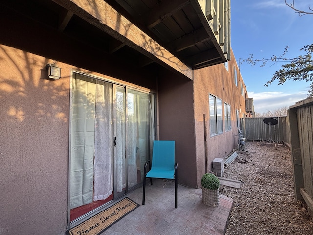 exterior space featuring fence and stucco siding