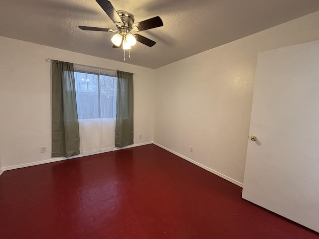 unfurnished room with a ceiling fan, baseboards, and a textured ceiling