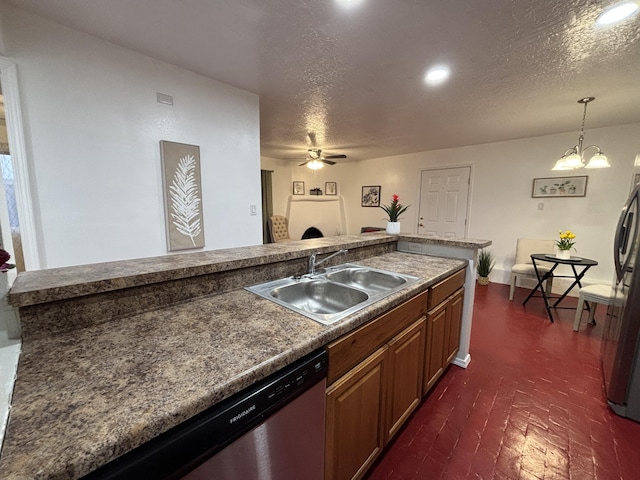 kitchen featuring a textured ceiling, brick floor, ceiling fan with notable chandelier, a sink, and decorative light fixtures