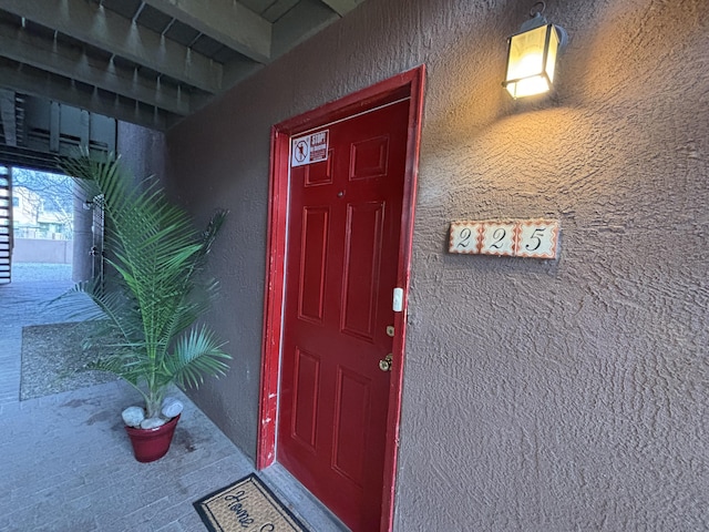 doorway to property with stucco siding