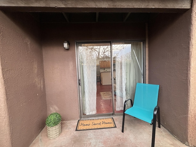 doorway to property with stucco siding