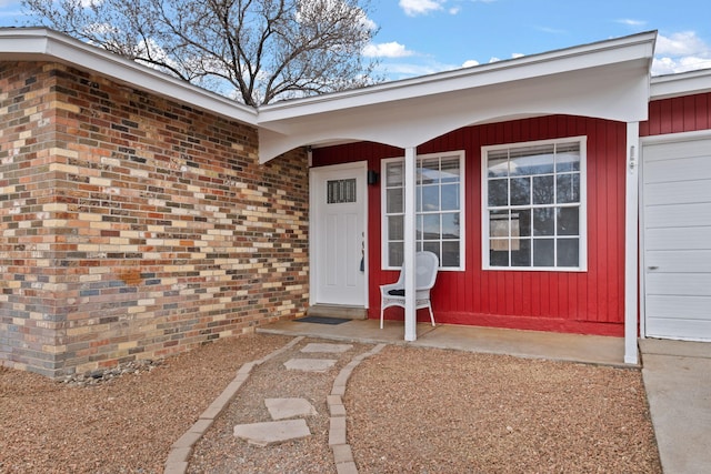 entrance to property featuring brick siding