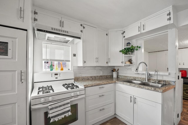 kitchen featuring sink, white gas stove, and white cabinets