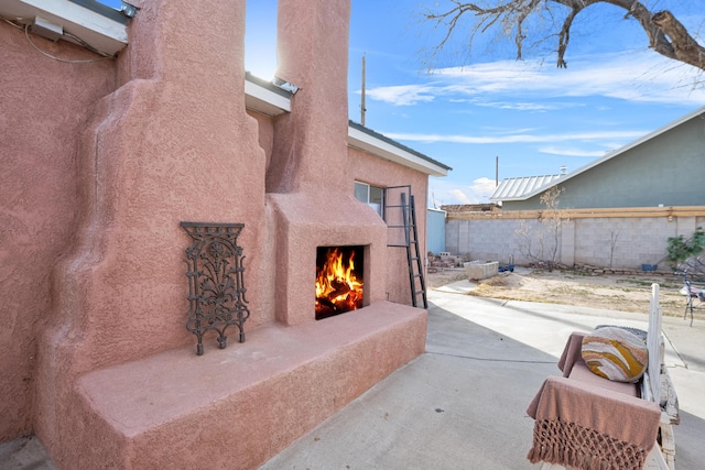 view of patio / terrace featuring an outdoor fireplace