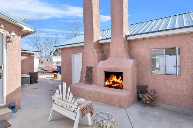 view of patio / terrace with an outdoor fireplace