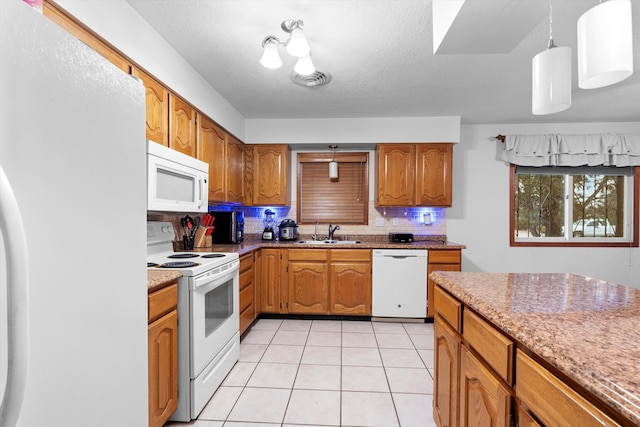 kitchen featuring decorative light fixtures, tasteful backsplash, sink, light tile patterned floors, and white appliances