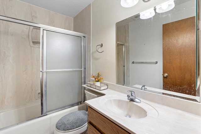 full bathroom with enclosed tub / shower combo, vanity, and toilet