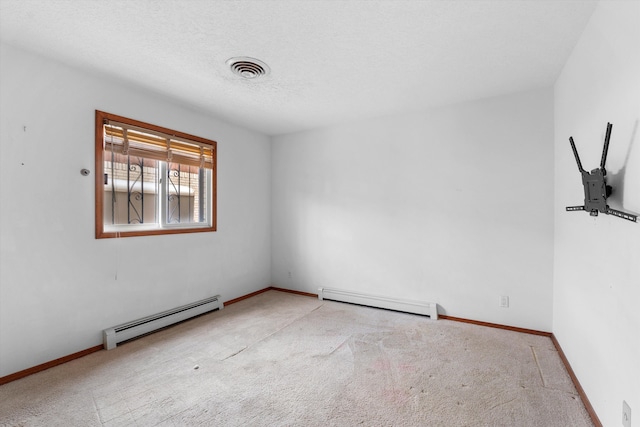 carpeted empty room with a baseboard radiator and a textured ceiling