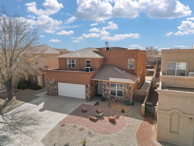 pueblo-style home featuring a garage