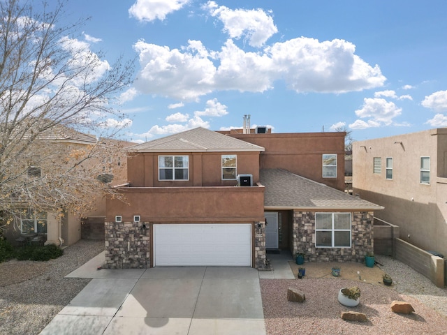 view of front of home with central AC unit and a garage