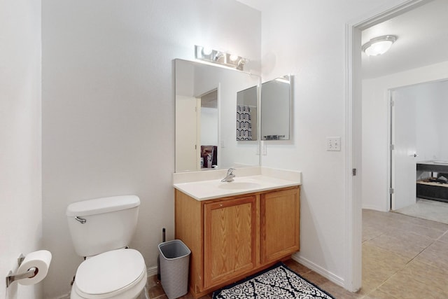 bathroom with vanity, tile patterned floors, and toilet