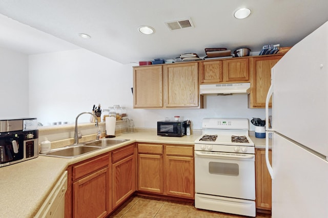 kitchen with white appliances, sink, and light tile patterned floors