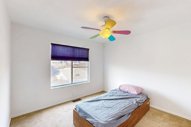 bedroom with ceiling fan and light colored carpet