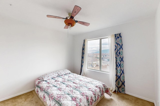bedroom with light carpet and ceiling fan