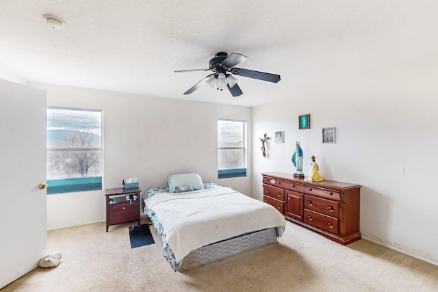 bedroom with light colored carpet and ceiling fan