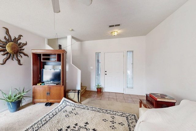 carpeted living room featuring ceiling fan