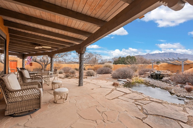 view of patio featuring a pergola and a mountain view