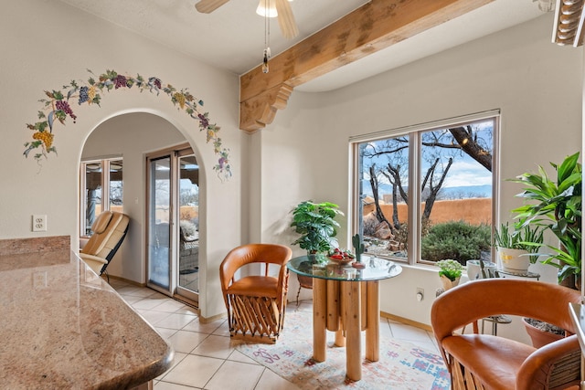 8008 Loma Larga Rd, Corrales, NM 87048 - dining space with light tile patterned floors, arched walkways, and ceiling fan