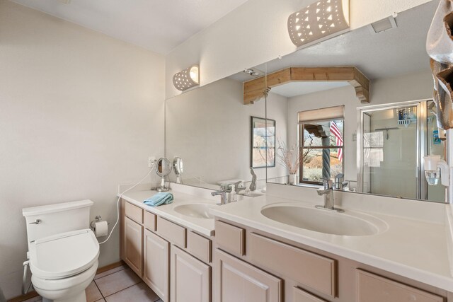 8008 Loma Larga Rd, Corrales, NM 87048 - bathroom with double vanity, toilet, a stall shower, and tile patterned flooring