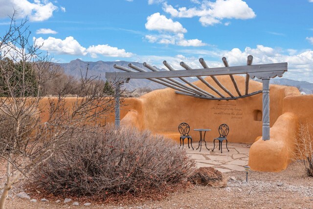 8008 Loma Larga Rd, Corrales, NM 87048 - view of patio featuring a mountain view