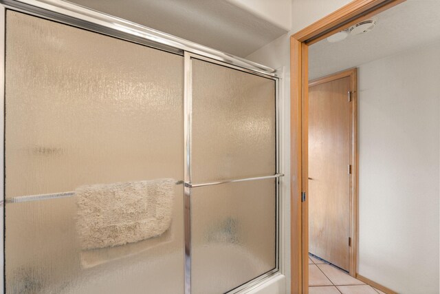 8008 Loma Larga Rd, Corrales, NM 87048 - bathroom with tile patterned floors and combined bath / shower with glass door