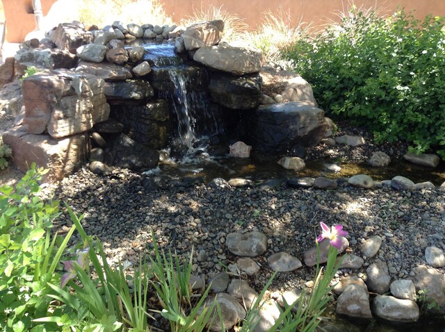 8008 Loma Larga Rd, Corrales, NM 87048 - exterior view of a garden pond