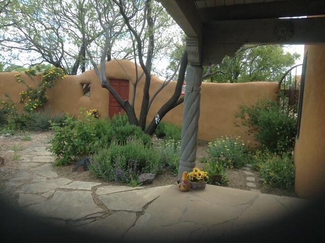 8008 Loma Larga Rd, Corrales, NM 87048 - view of home's exterior featuring a fenced backyard and a patio