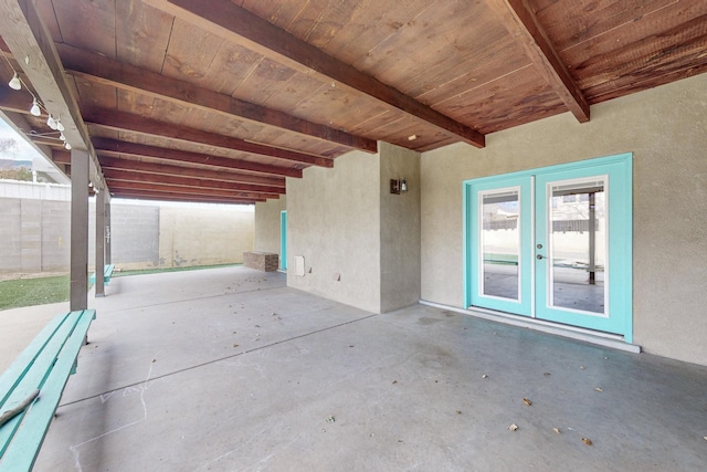 view of patio with french doors and fence