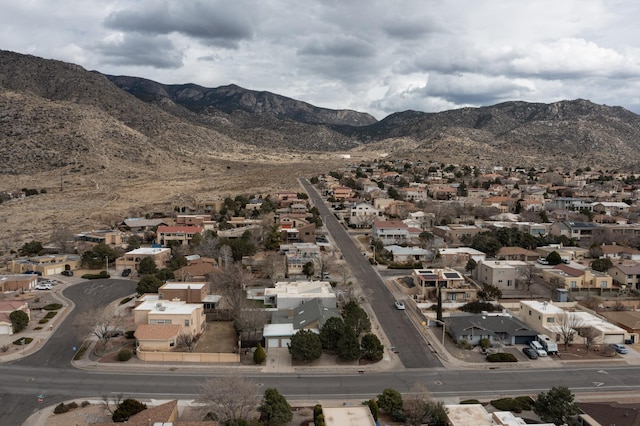 birds eye view of property with a mountain view and a residential view