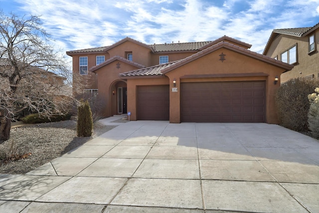 mediterranean / spanish house with a garage