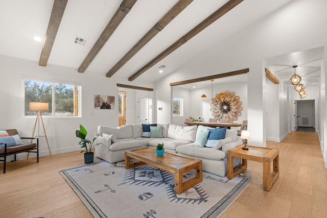 living area featuring vaulted ceiling with beams, light wood-style flooring, visible vents, and baseboards