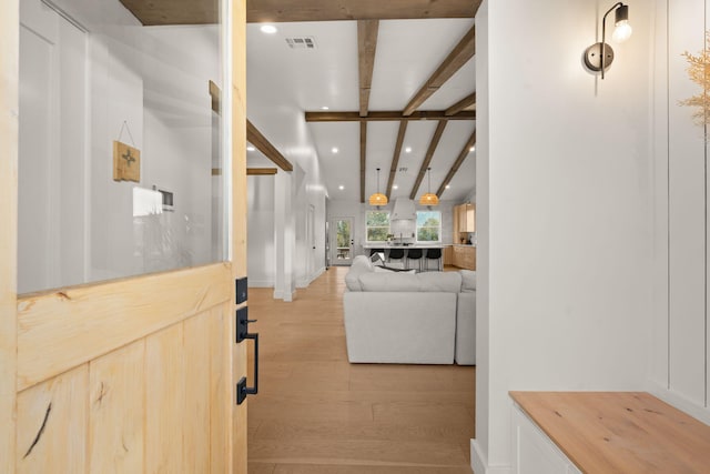 hall with light wood-style flooring, beamed ceiling, visible vents, and recessed lighting