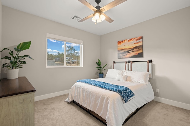 bedroom featuring baseboards, a ceiling fan, visible vents, and light colored carpet