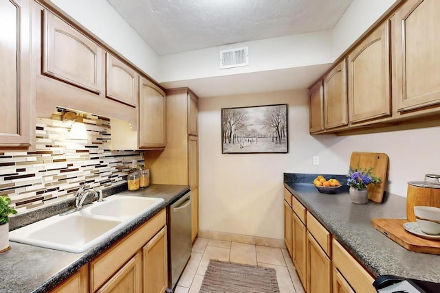 kitchen featuring sink, backsplash, light tile patterned flooring, light brown cabinetry, and stainless steel dishwasher