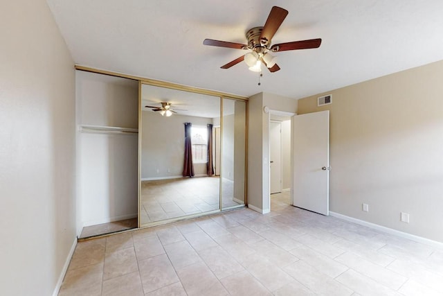 unfurnished bedroom with light tile patterned flooring and ceiling fan