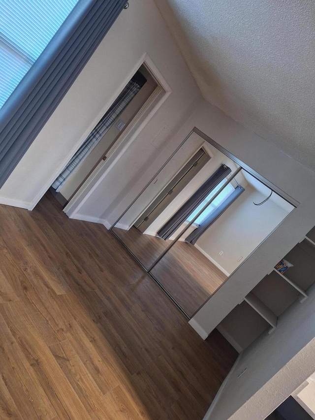 interior space with wood-type flooring and a textured ceiling