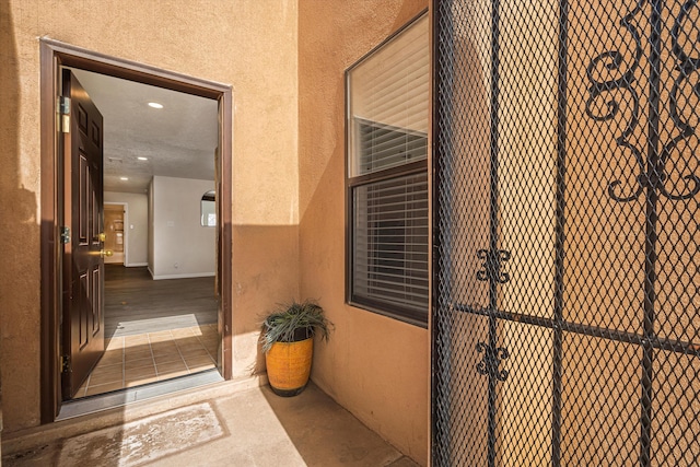 view of exterior entry with stucco siding