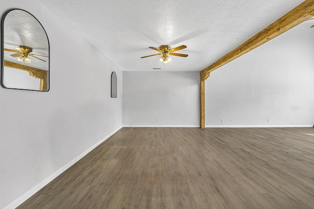 spare room featuring a ceiling fan, a textured ceiling, baseboards, and wood finished floors