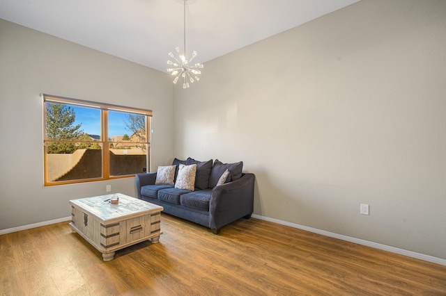 living room featuring an inviting chandelier and hardwood / wood-style floors