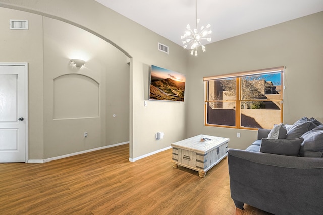 interior space with hardwood / wood-style flooring and a chandelier