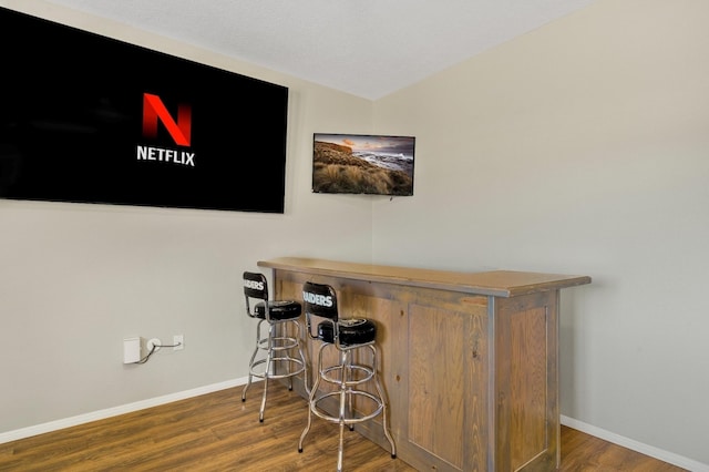 bar featuring hardwood / wood-style flooring