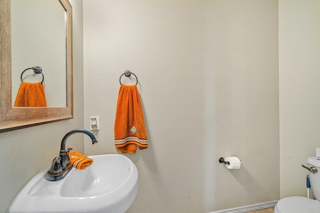 bathroom featuring sink and toilet