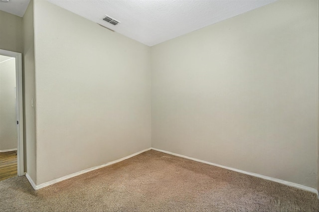 empty room featuring carpet floors and a textured ceiling