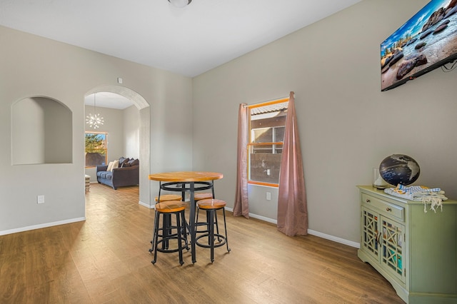 dining room featuring an inviting chandelier and light hardwood / wood-style flooring