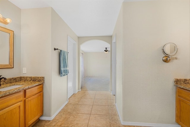 corridor featuring tile patterned floors and vanity