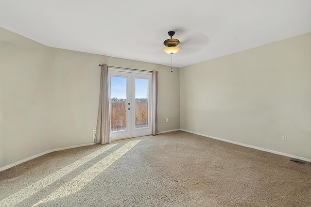 carpeted empty room with french doors