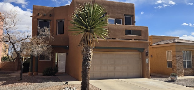 pueblo-style house with a garage