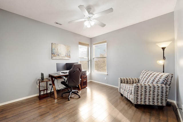 office space with dark wood-type flooring and ceiling fan