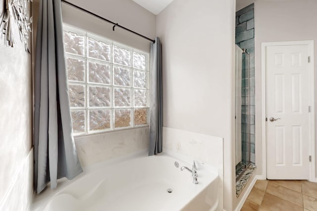 bathroom featuring tile patterned flooring, separate shower and tub, and a wealth of natural light