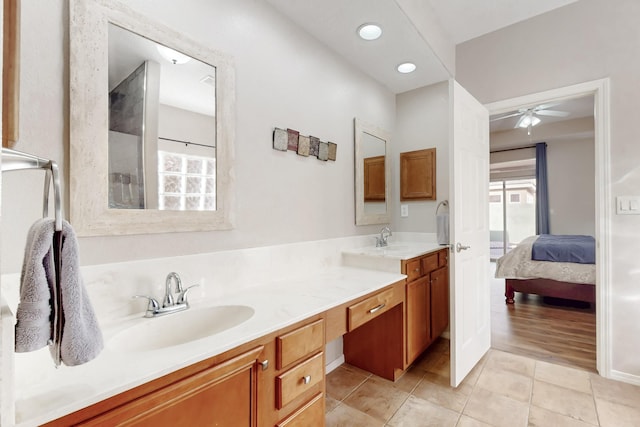 bathroom featuring vanity, a wealth of natural light, tile patterned floors, and ceiling fan